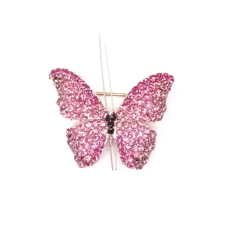 Broche papillon pavée de pierres scintillantes roses vue de face.