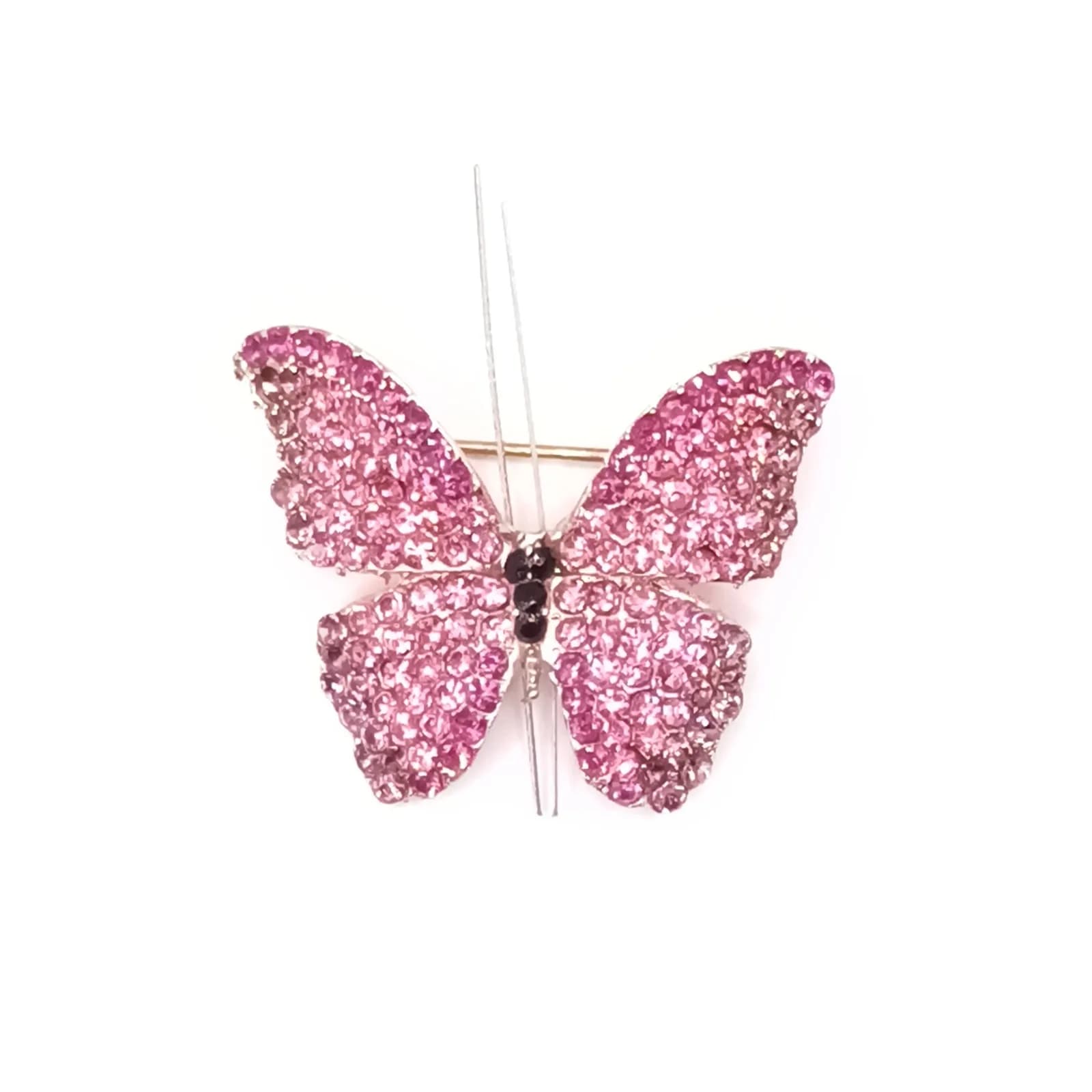 Broche papillon pavée de pierres scintillantes roses vue de face.